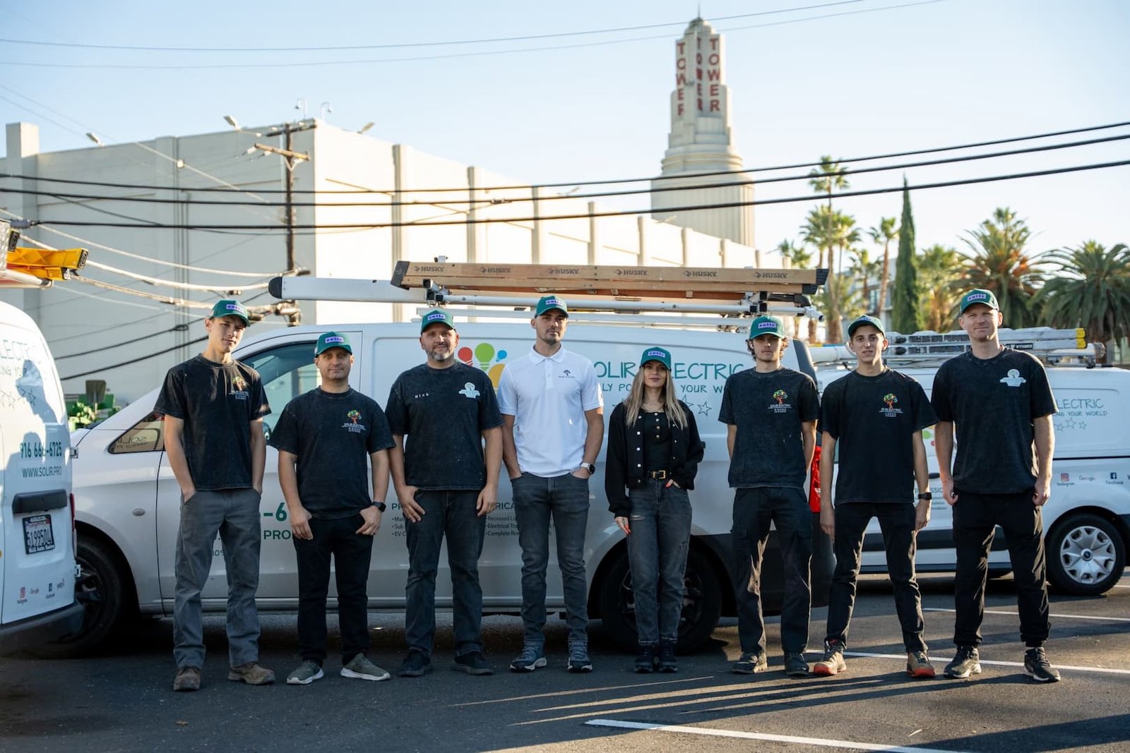 Solir Electric team standing beside a branded service van